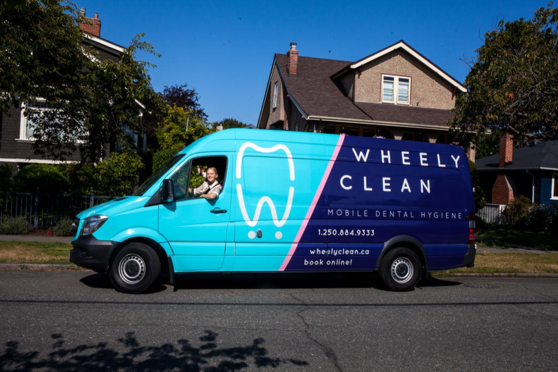 A Wheely Clean van parked on a tree-lined Victoria street